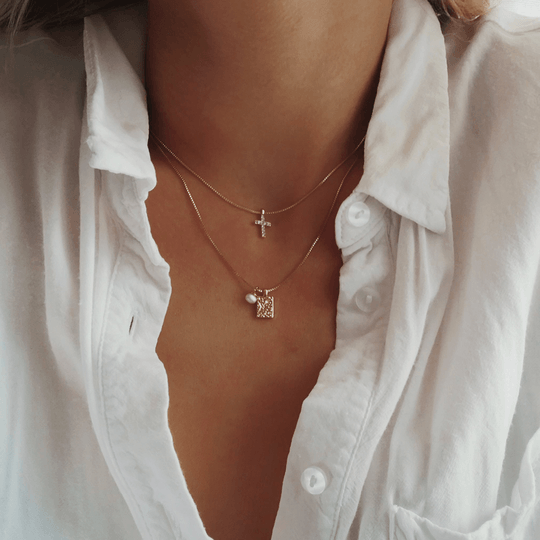 Necklace with a sales cross on it